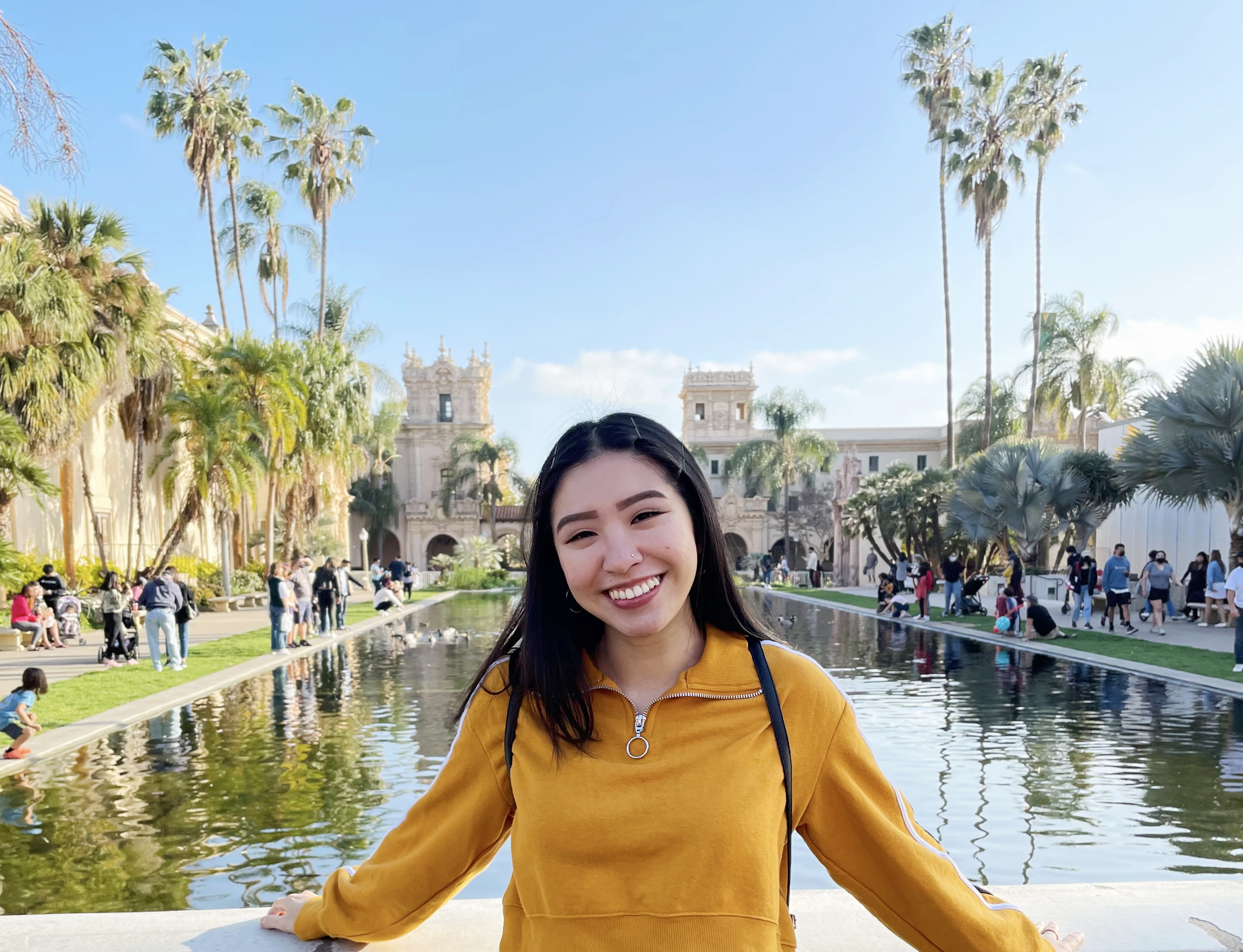 Leslie smiling in the center of Balboa Park in San Diego